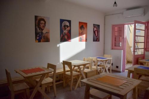 a room with tables and chairs and pictures on the wall at Hostel San Rafael - Bed & Breakfast in San Rafael