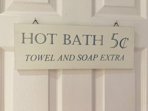 a sign on a door that reads hot bath to reveal and soap extra at No.18 - Ground Floor apartment close to the beach in Cromer