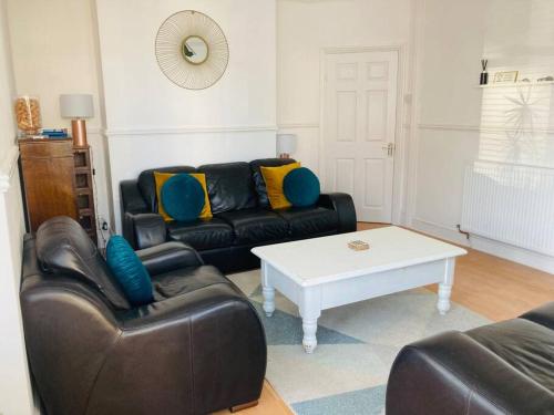 a living room with a couch and a table at No.18 - Ground Floor apartment close to the beach in Cromer