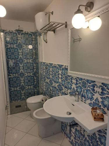 a bathroom with a sink and a toilet at Tre Re Appartamento Matima in Capri