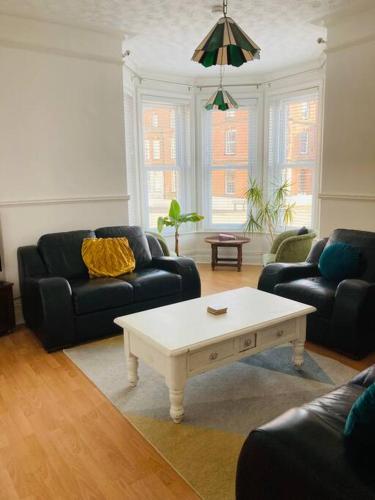 a living room with two couches and a coffee table at No.18 - Ground Floor apartment close to the beach in Cromer