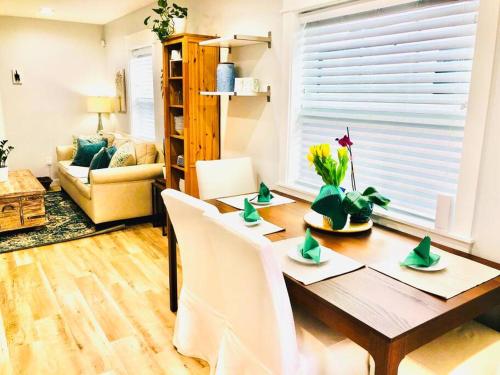 a living room with a dining room table with chairs at The 2 Bedroom Jacksonville Blue Bungalow in Jacksonville