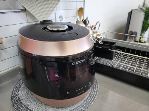 a slow cooker sitting on a counter in a kitchen at Donghae Hanok Stay in Donghae