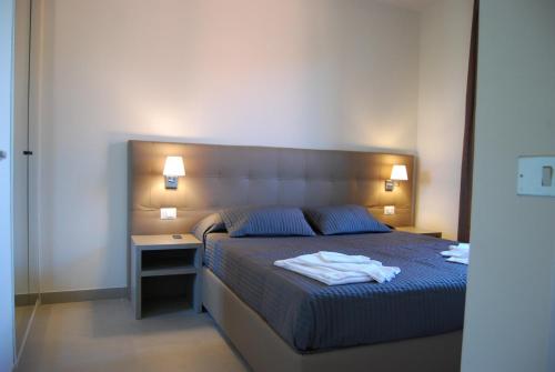 Katil atau katil-katil dalam bilik di Residenze Al Colle Dei Pini
