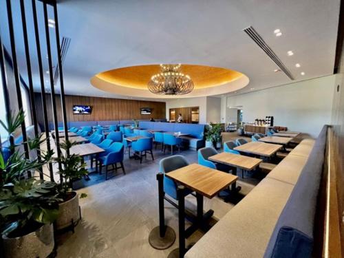 a restaurant with blue tables and blue chairs at Holiday Inn Express Morelia, an IHG Hotel in Morelia