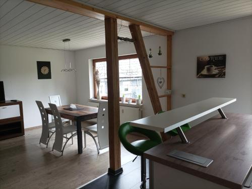 a living room with a table and chairs and a dining room at Ferienwohnung zur Alten Brauerei, free Wi-Fi+Parken, 3 Schlafzimmer, Grillecke in Lehesten