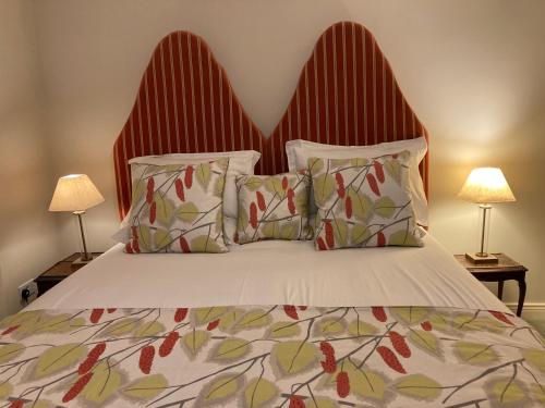a bedroom with a large bed with two lamps at Self Catering Apartment- 11A Westbourne Place in Cobh