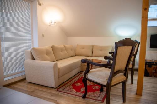 a living room with a couch and a chair at Apartman Centar in Sremski Karlovci