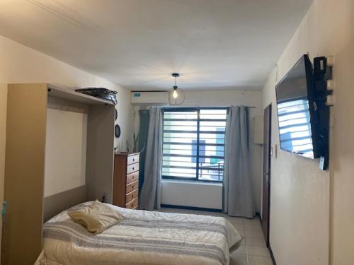 a bedroom with a bed and a large window at Mono corrientes in Santa Fe
