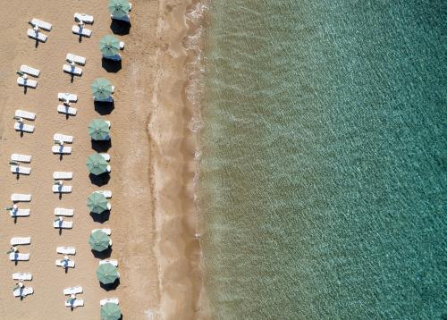 an overhead view of a beach with chairs and umbrellas at Blue Sea Karpasia Hotel in Rizokarpaso