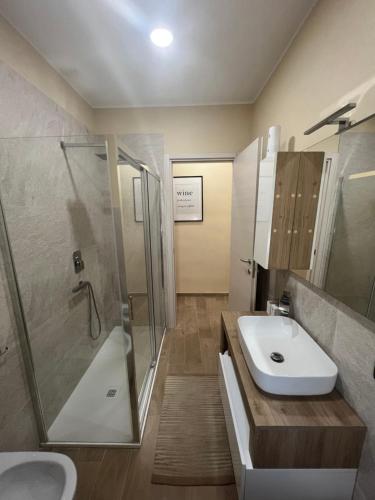 a bathroom with a sink and a shower and a toilet at Cecco Guest house in Pisa