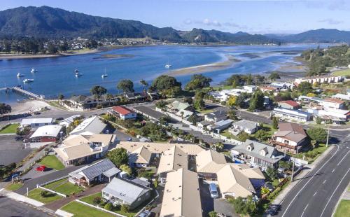 an aerial view of a town next to a river at Tairua Shores Motel in Tairua