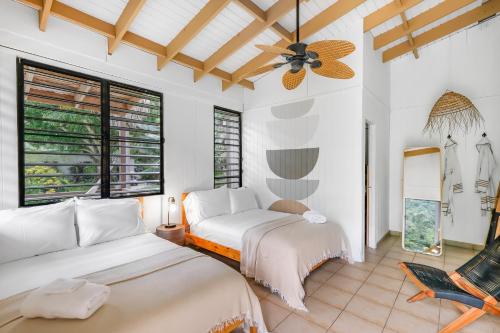 a living room with two beds and a ceiling fan at Casa Grande Mountain Retreat - Adults Only in Utuado