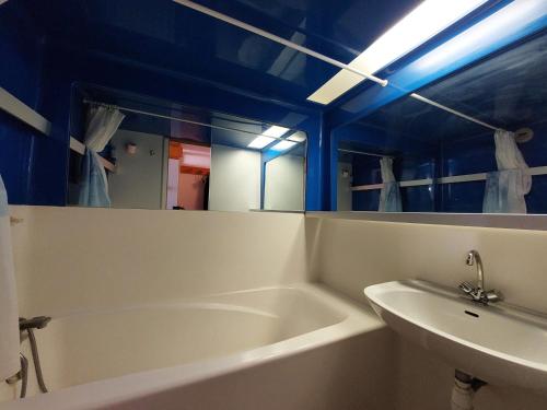 une salle de bain avec une baignoire, un lavabo et un miroir dans l'établissement Agréable duplex 6 pers, au dernier étage, 2 balcons, animaux admis - FR-1-411-731, à Bourg-Saint-Maurice