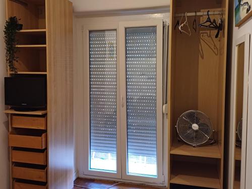 a glass door with a window with blinds at Amoreira Room I and II in Lisbon
