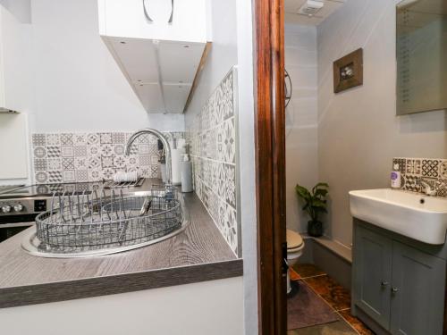 a bathroom with a sink and a toilet at Rusland View in Ulverston