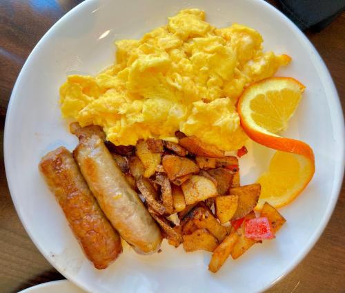 a plate of breakfast food with eggs sausage and potatoes at Canopy by Hilton Washington DC Embassy Row in Washington