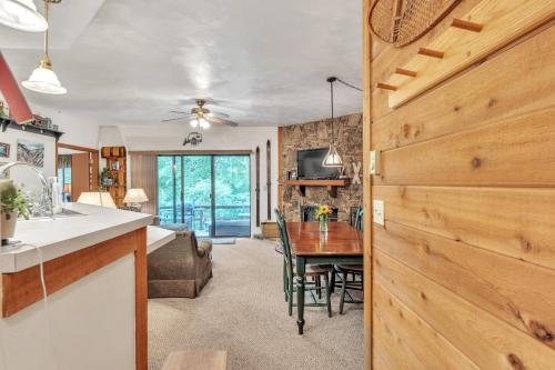 a kitchen and dining room with a table and a room at 7 Springs Ski & Mountain Adventure Condo condo in Champion
