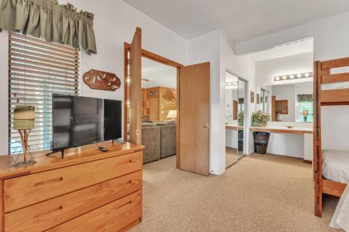 a bedroom with a flat screen tv on a dresser at 7 Springs Ski & Mountain Adventure Condo condo in Champion