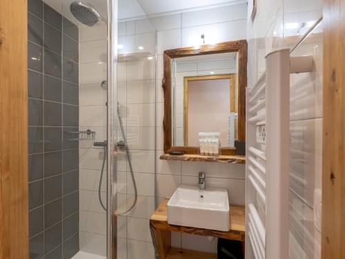 a bathroom with a sink and a shower and a mirror at Appartement Val Thorens, 2 pièces, 4 personnes - FR-1-640-10 in Val Thorens