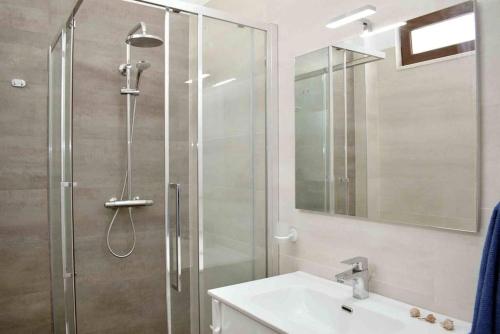 a bathroom with a shower with a sink and a mirror at Super Villa for vacation Gjiri i Lalzit in Draç