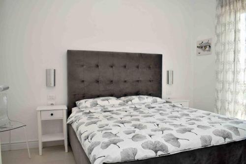 a bedroom with a large bed and two night stands at Super Villa for vacation Gjiri i Lalzit in Draç