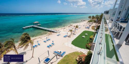 a view of the beach from the balcony of a resort at Rum Point Club Resort Luxury Beachfront Condos by Grand Cayman Villas & Condos in Driftwood Village