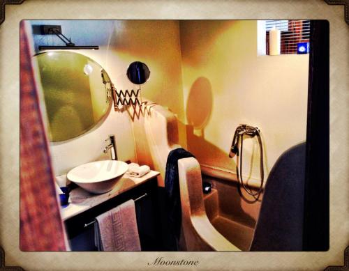 a bathroom with a sink and a mirror at Aperanto Galazio in Skopelos Town