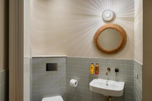 a bathroom with a sink and a mirror at Rezident Tomis Marina in Constanţa