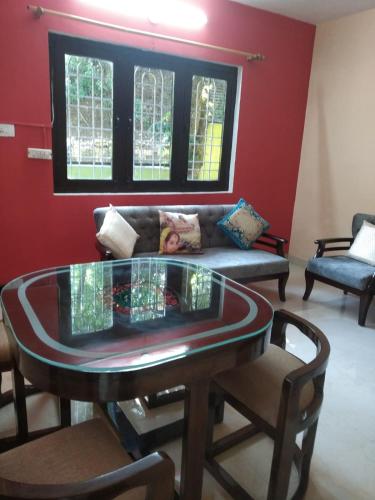 a living room with a glass table and a couch at Bhawani Kutir Villa Nainital in Nainital