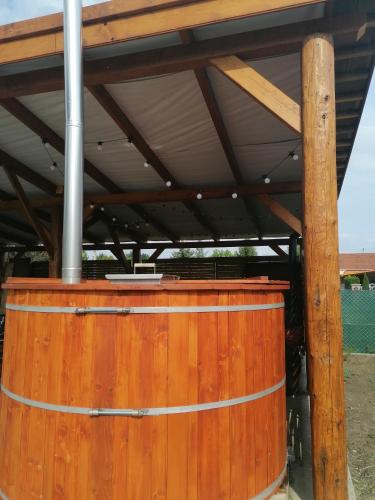 a wooden barrel with a roof on top of it at Borács Winedégház in Bogács