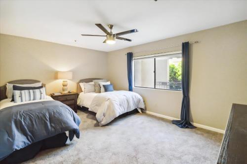 a bedroom with two beds and a window at Biltmore Bliss Desert Retreat! in Phoenix