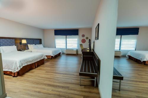 a hotel room with two beds and wooden floors at Hampton By Hilton San Jose Airport Costa Rica in Alajuela City