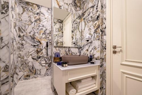 a bathroom with a sink and a mirror at Blue Sea Karpasia Hotel in Rizokarpaso