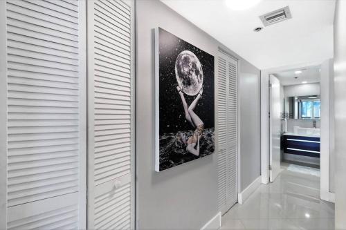 a hallway with a painting of a woman on the wall at Meet Me in Miami! Impressive Miami Skyline Views in Miami