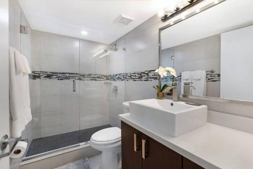 a bathroom with a sink and a toilet and a shower at Meet Me in Miami! Impressive Miami Skyline Views in Miami