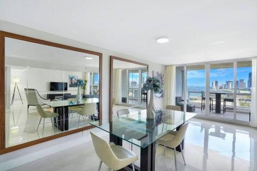 a dining room with a glass table and chairs at Meet Me in Miami! Impressive Miami Skyline Views in Miami