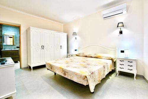 a bedroom with a large bed and a white cabinet at Can Biel in Pina