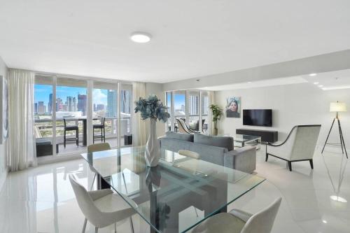 a living room with a glass table and chairs at Meet Me in Miami! Impressive Miami Skyline Views in Miami