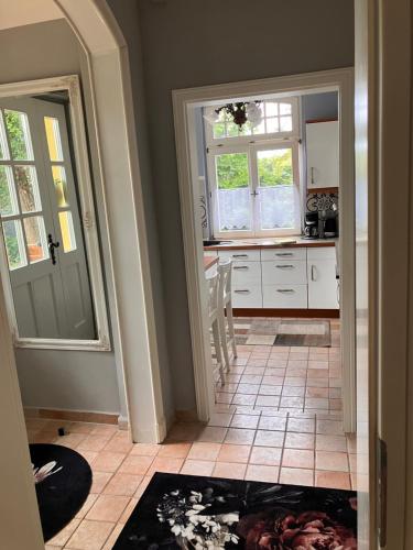 a kitchen with a door leading into a kitchen with a counter at Castrum Visum Wernigerode in Wernigerode