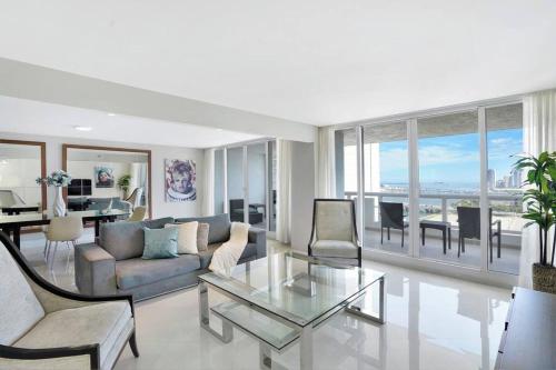 a living room with a couch and a glass table at Meet Me in Miami! Impressive Miami Skyline Views in Miami