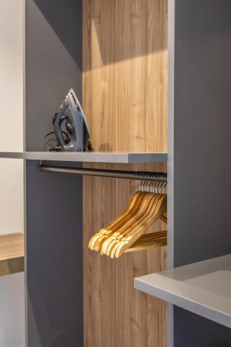 a refrigerator with wooden doors with wooden utensils at Heated Luxury Poolside Retreat in St Julian s in Pembroke 