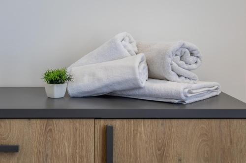 a pile of towels sitting on top of a counter at Heated Luxury Poolside Retreat in St Julian s in Pembroke 