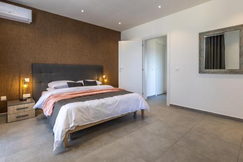 a bedroom with a large bed in a room at Private Penthouse with Heated Spa Bath Pembroke St Julians in Pembroke