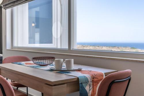 a dining room with a table and chairs and a window at Heated Luxury Poolside Retreat in St Julian s in Pembroke 