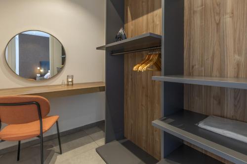 a dressing room with a mirror and a chair at Heated Luxury Poolside Retreat in St Julian s in Pembroke 