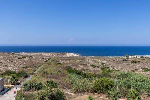 a view of the ocean from a house at Heated Luxury Poolside Retreat in St Julian s in Pembroke 