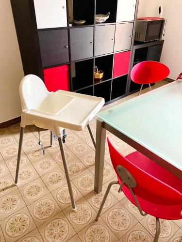 a room with a desk and a red chair at HOME - Alessandra Holiday House in Piove di Sacco