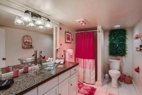 a bathroom with a sink and a toilet at Barbie's Dream Apt in the City in Sacramento
