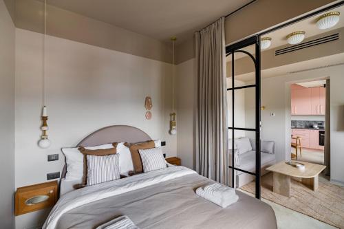 a bedroom with a large bed and a living room at Rezident Tomis Marina in Constanţa